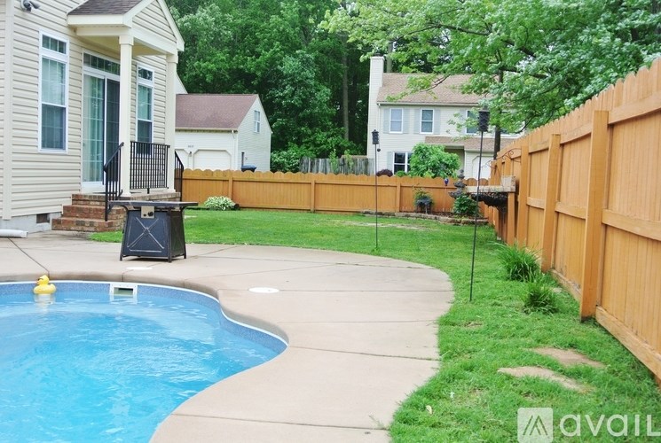 A pool in a backyard with a fence around it.