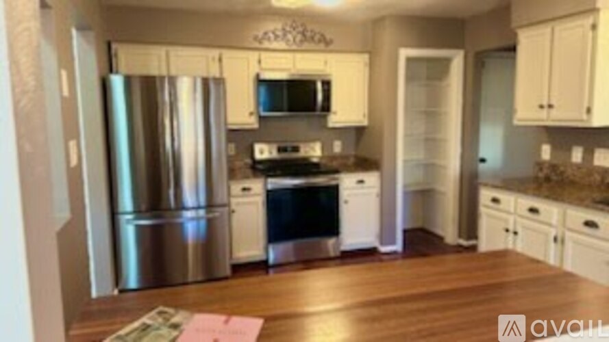 A house with a porch and a white picket fence.