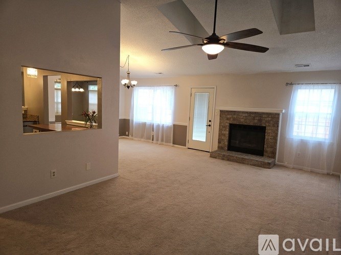 A bedroom with a bed covered in a baseball-themed blanket.