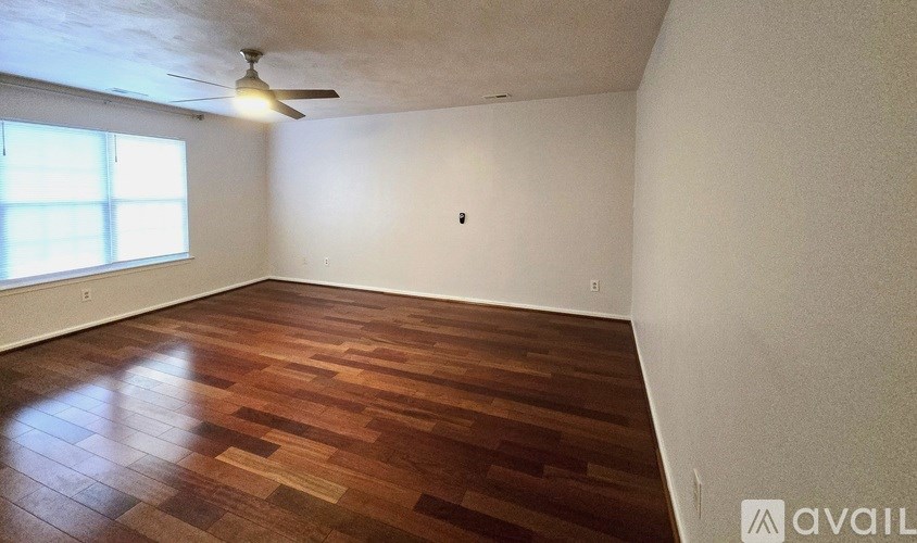 A house with a brick facade and a grey roof with a white garage door.