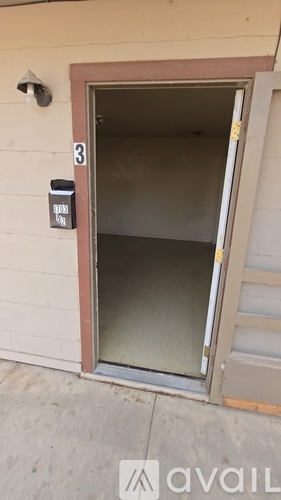 A door with a number 3 on it and a mailbox on the wall.