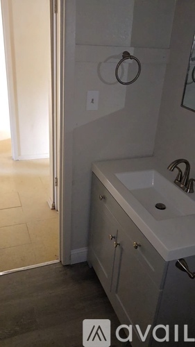 A bathroom with a white tub and a towel ring on the wall.