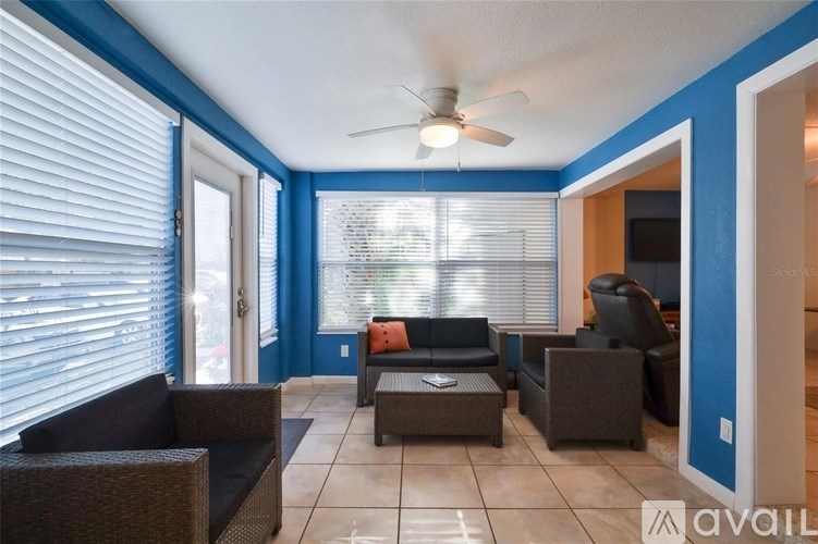 A living room with a ceiling fan and a couch.