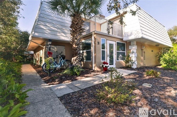 A house with a bicycle parked in front of it.