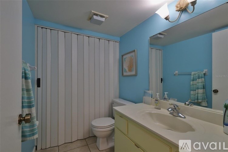 A bathroom with blue walls and a white toilet.