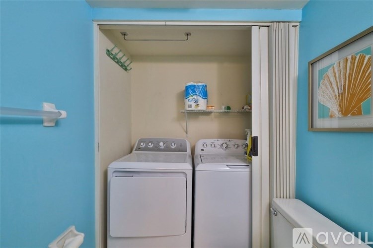 A small laundry room with a washer and dryer.