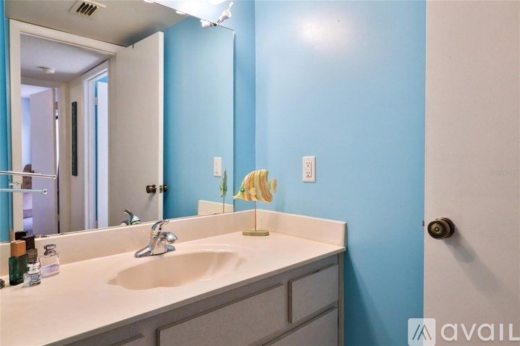 A bathroom with blue walls and a white sink.