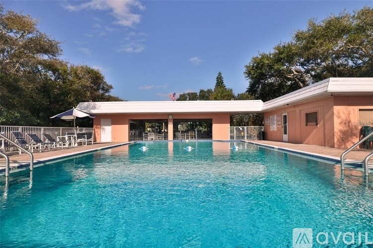 A large outdoor swimming pool with a building in the background.