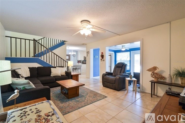 A living room with a couch, chair, and a rug.
