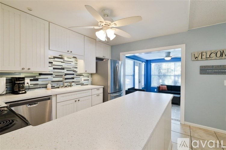 A kitchen with white cabinets and a countertop.