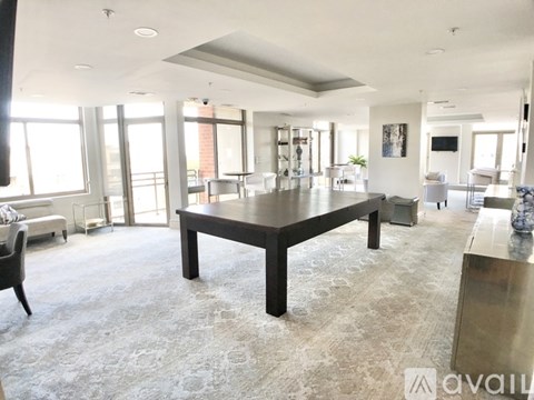 A spacious living room with a large table and chairs.