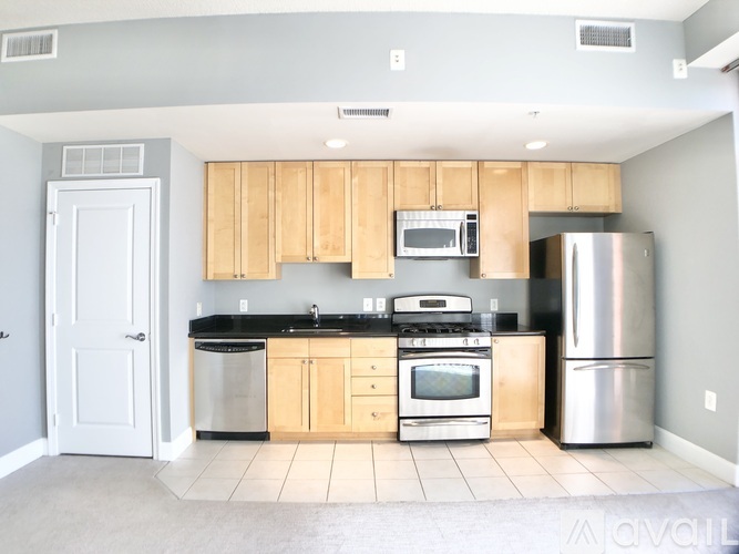 A kitchen with wooden cabinets and stainless steel appliances.