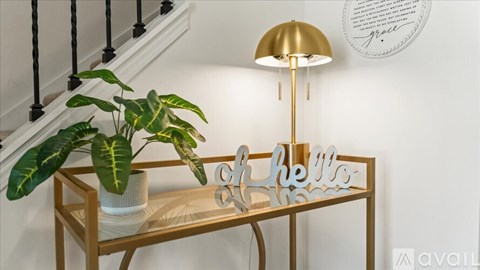 A table with a lamp and a plant on it.