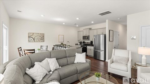 A modern living room with a grey sofa and a glass coffee table.