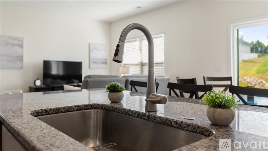A kitchen with a sink and a window.