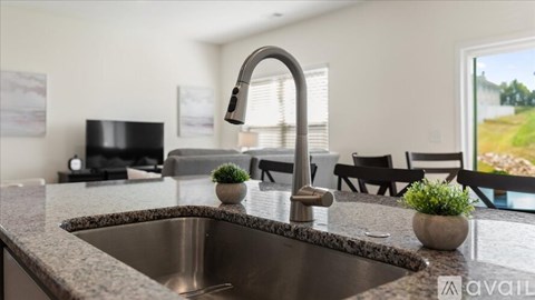 A kitchen with a sink and a window.