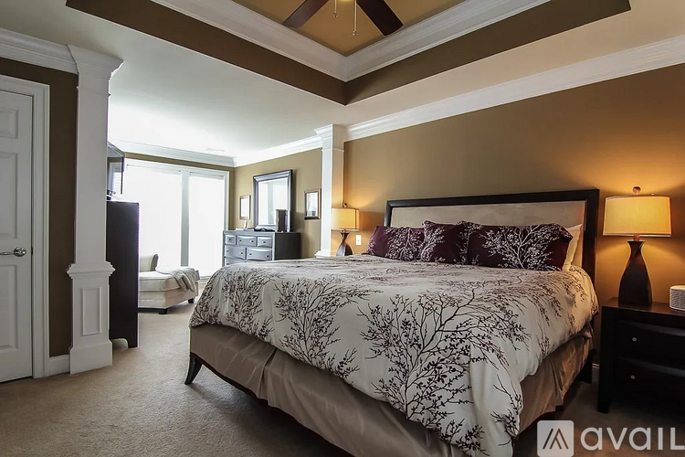 A bedroom with a large bed and a window.