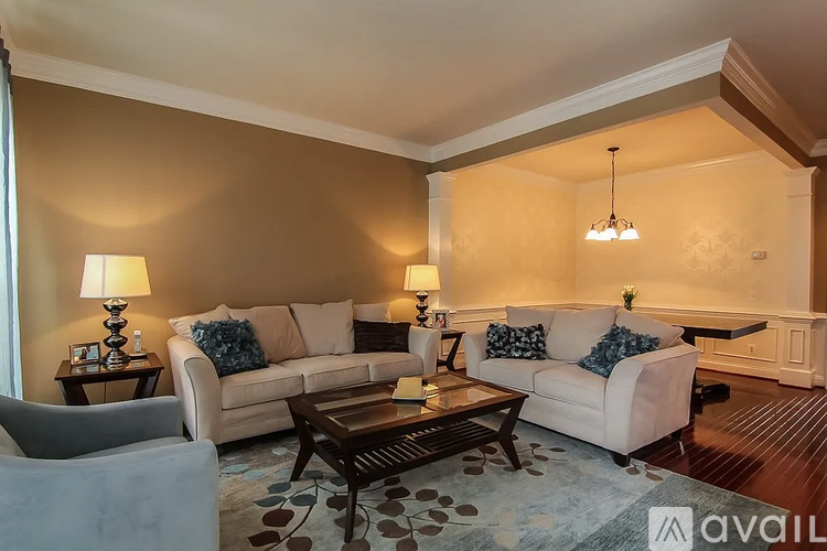 A living room with a couch, chair, and coffee table.