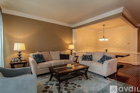A living room with a couch, chair, and coffee table.