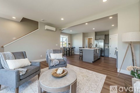 A living room with grey couches and a coffee table.
