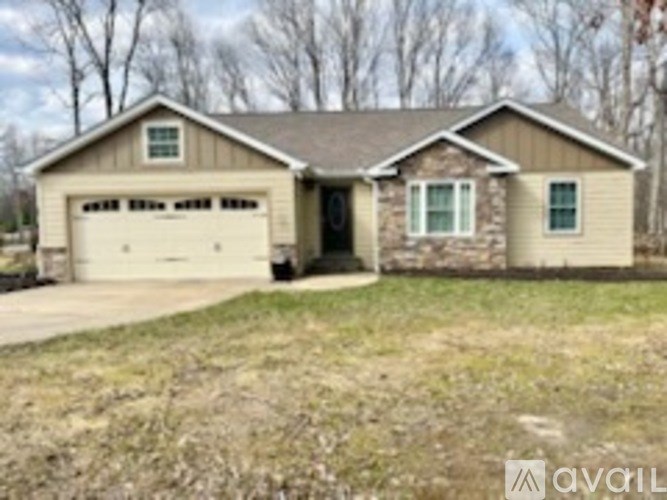A two-story house with a garage is for sale.