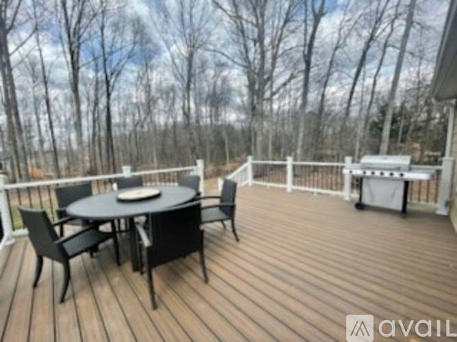A wooden deck with a table and chairs.