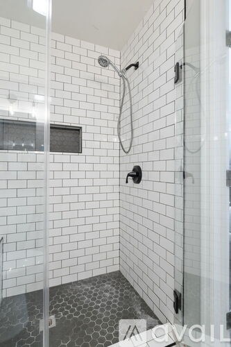 A bedroom with a large bed and two lamps.