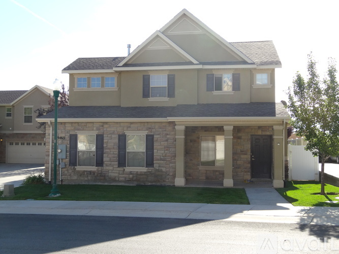 A house with a brown and beige exterior is shown.