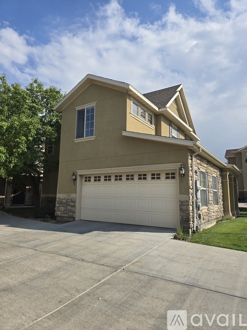 A two-story house with a garage is available for sale.