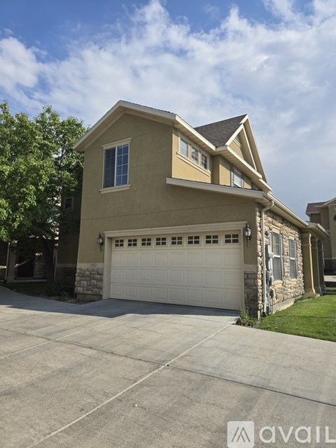 A two-story house with a garage is available for sale.