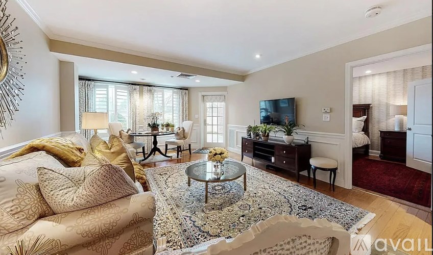 A living room with a sofa, coffee table, and television.