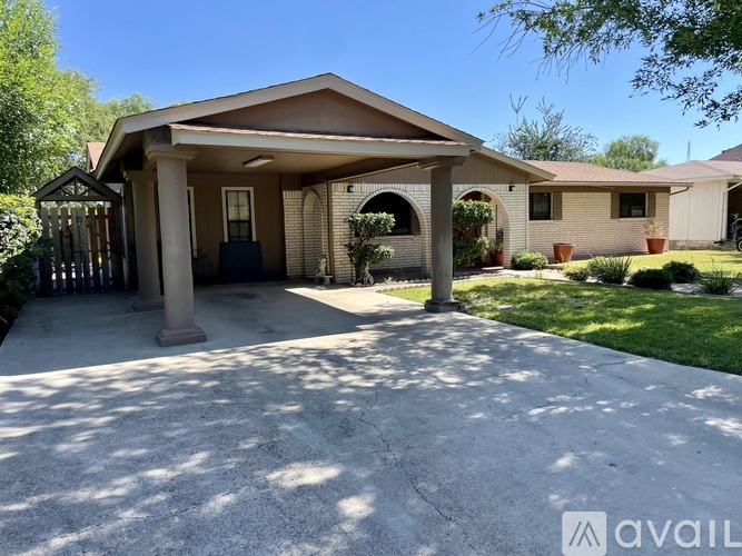 A house with a covered patio and a driveway.