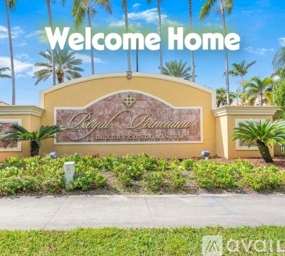 A sign that says "Welcome Home" is in front of a building with palm trees in the background.