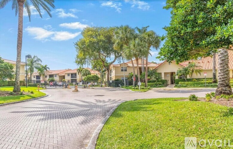 A sunny day at a residential area with palm trees and houses.