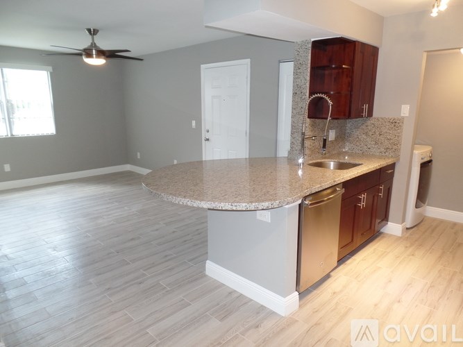 A kitchen with a countertop and cabinets is available for rent.
