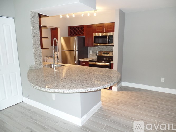 A kitchen with granite countertops and stainless steel appliances.