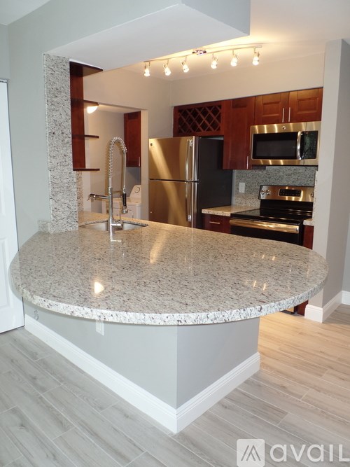 A kitchen with granite countertops and stainless steel appliances.