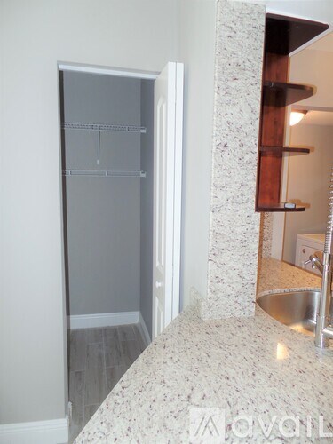 A white fridge in a kitchen with a marble counter top.