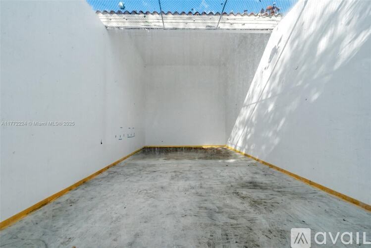 A room with white walls and a concrete floor.