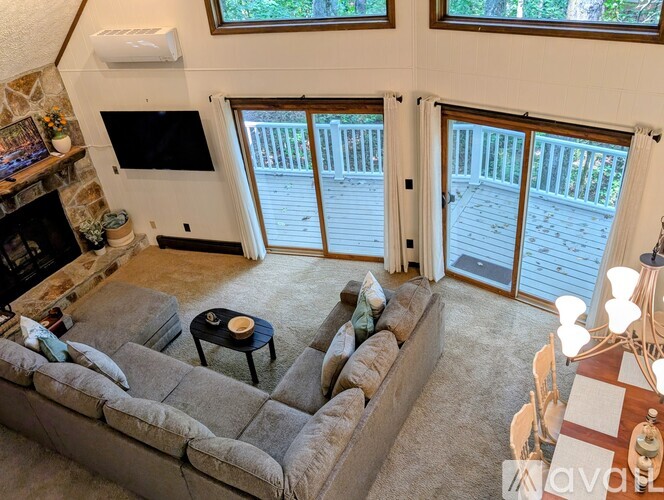 A bedroom with a bed, a dresser, and a television.