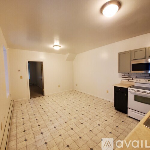 A kitchen with a black and white checkered floor.