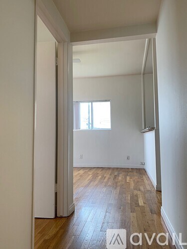 A room with wooden floors and white walls.