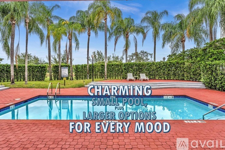 A pool surrounded by palm trees with a sign that says "Charming Small Pool, Larger Options For Every Mood".