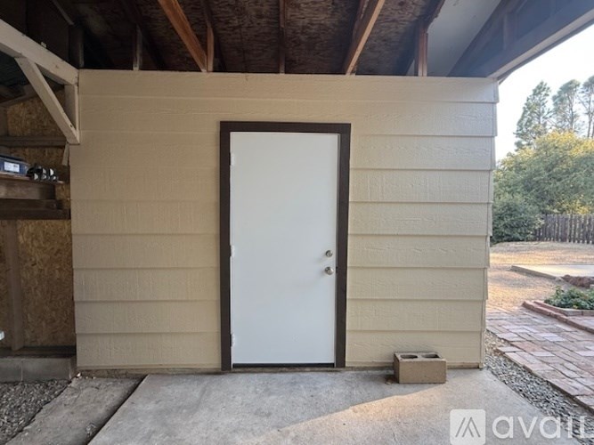 A white door is on the side of a house.