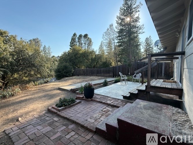 A backyard with a patio and a hot tub.