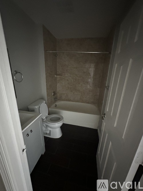 A small bathroom with a toilet and a bathtub.