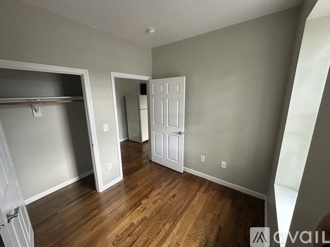 A room with a wooden floor and white walls.