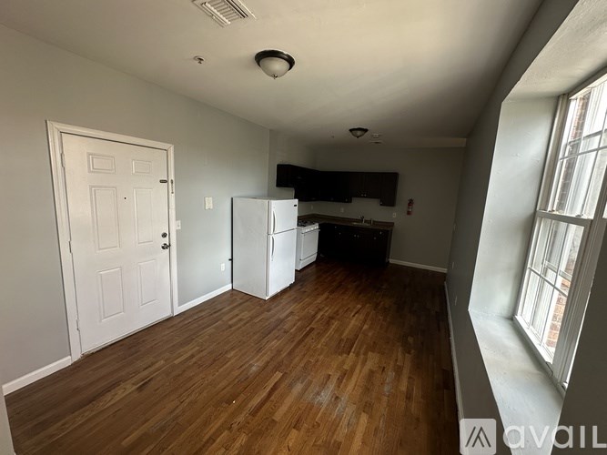 A room with wooden floors and a white door.