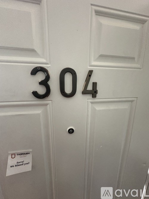 A white door with the number 304 on it.