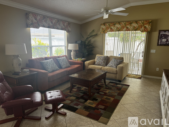 A kitchen with a table and chairs by a window.